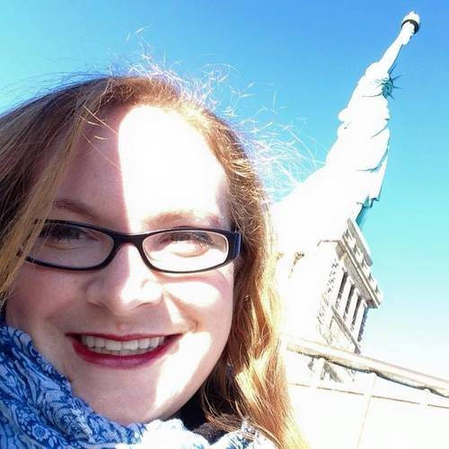 Alumna Trazy Collins in front of the Statue of Liberty